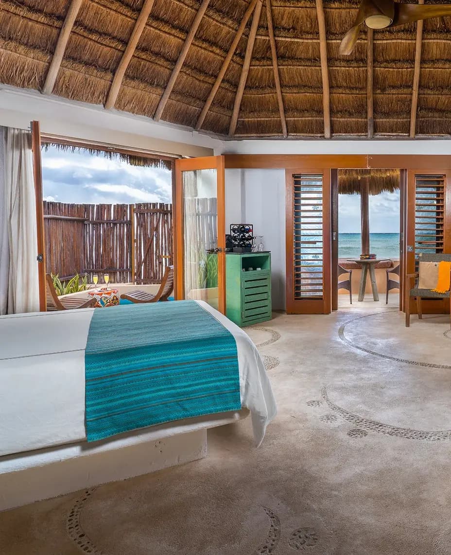 Ocean-view suite with a palapa roof and private terrace at Mahekal Beach Resort